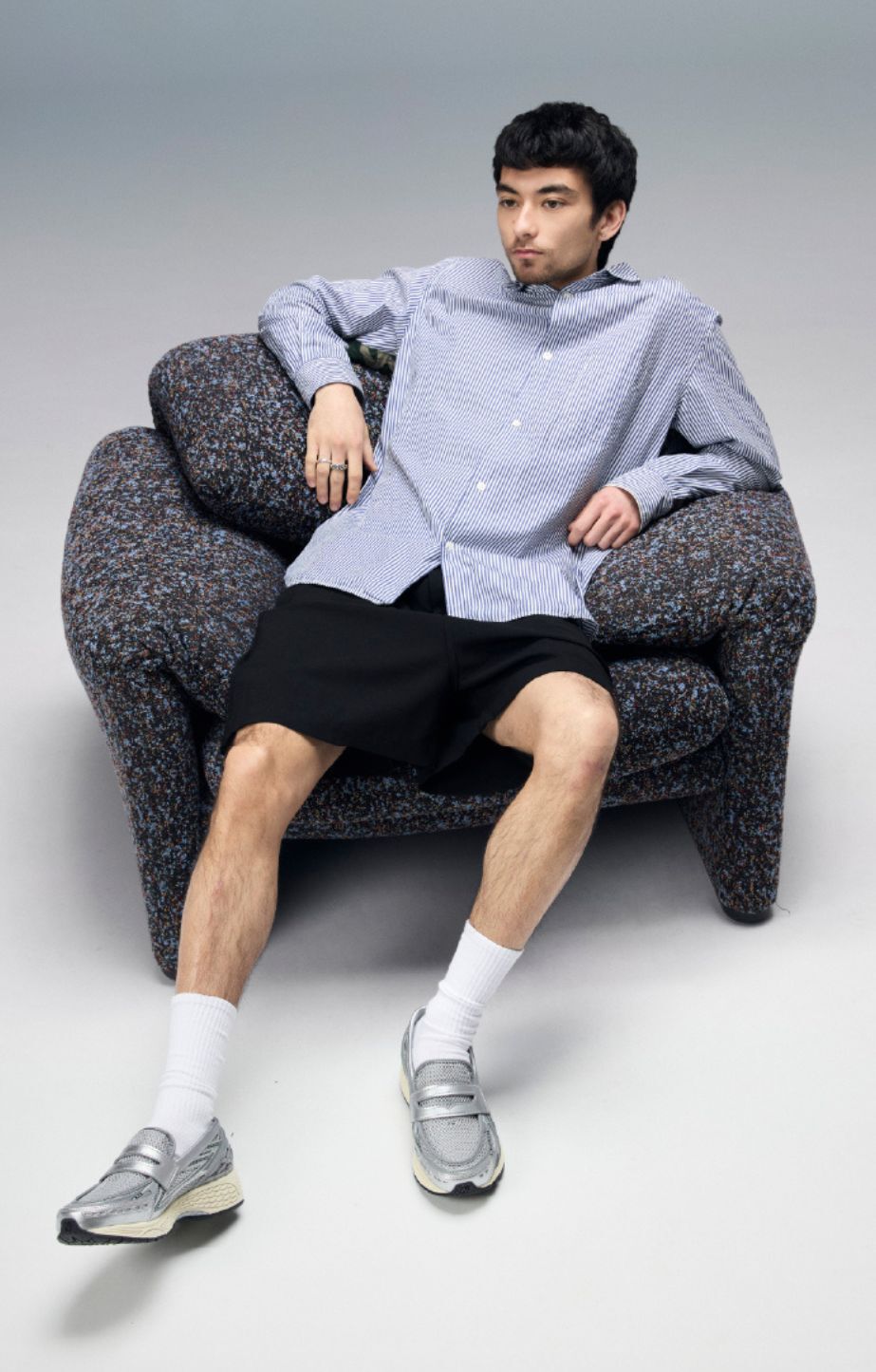 An individual stands wearing the 1906 sneakers